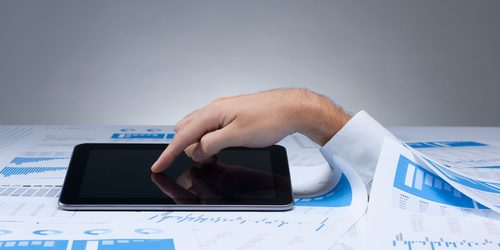 Drowning in Data Hand reaching through reports to a computer