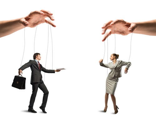 Pulling the strings Business people as puppets