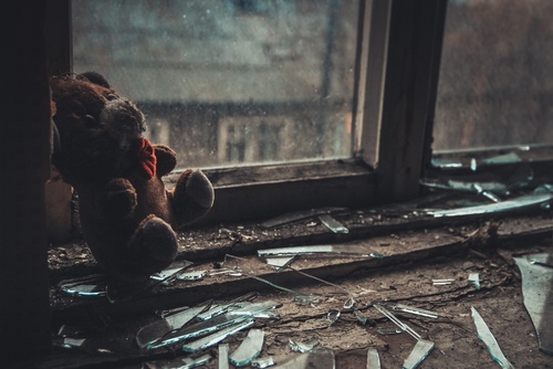 Distressed relationships teddy bear in a dismal scene