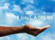 outstretched hand with cloudy sky