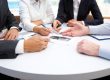 Group of business people discuss a contract