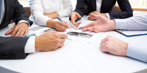 Commercial Discussions Group of business people discuss a contract