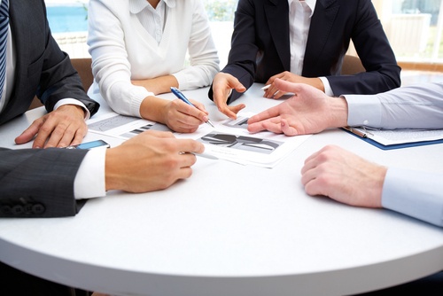 Commercial Discussions Group of business people discuss a contract