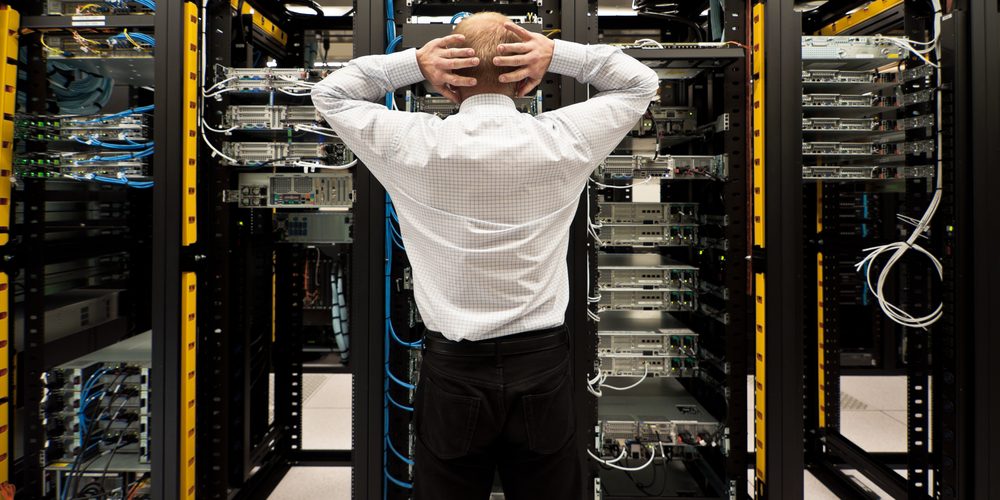 shutterstock_95440231 Distressed man in front of computer racks
