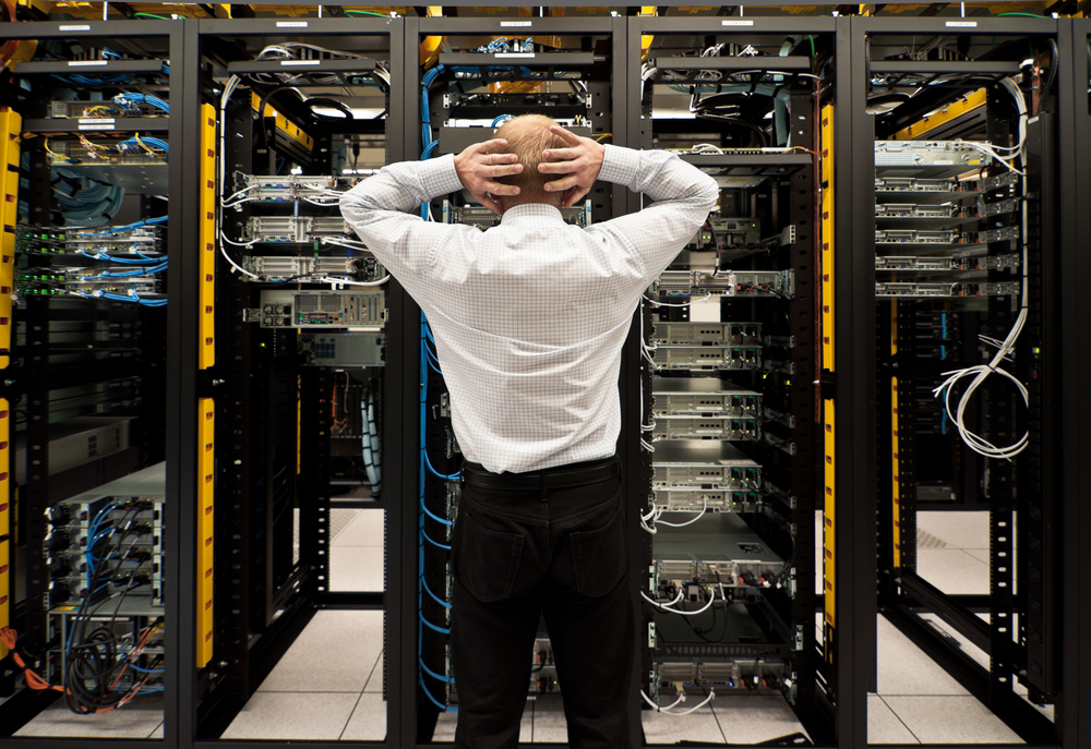 Distressed man in front of computer racks