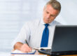 Professional man drafting a report